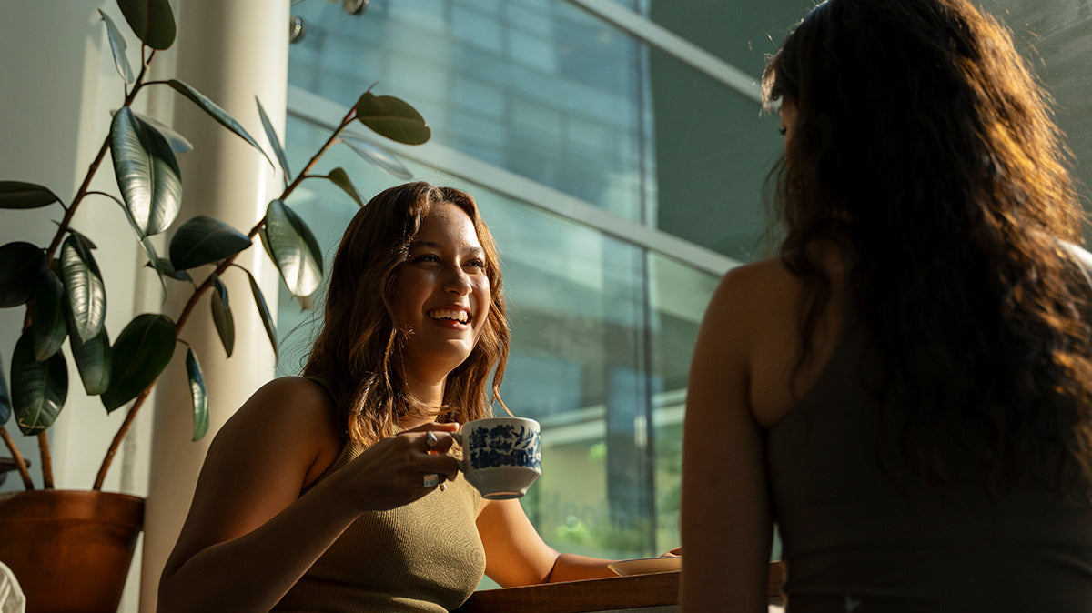 Two friends enjoying coffee in a café