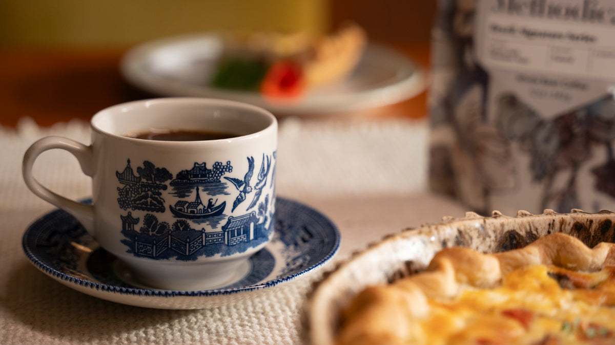 A cup of coffee paired with a quiche