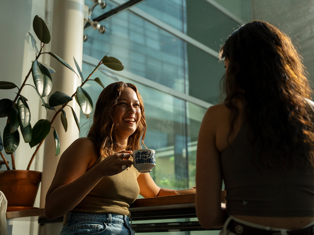 Two friends enjoying coffee in a café