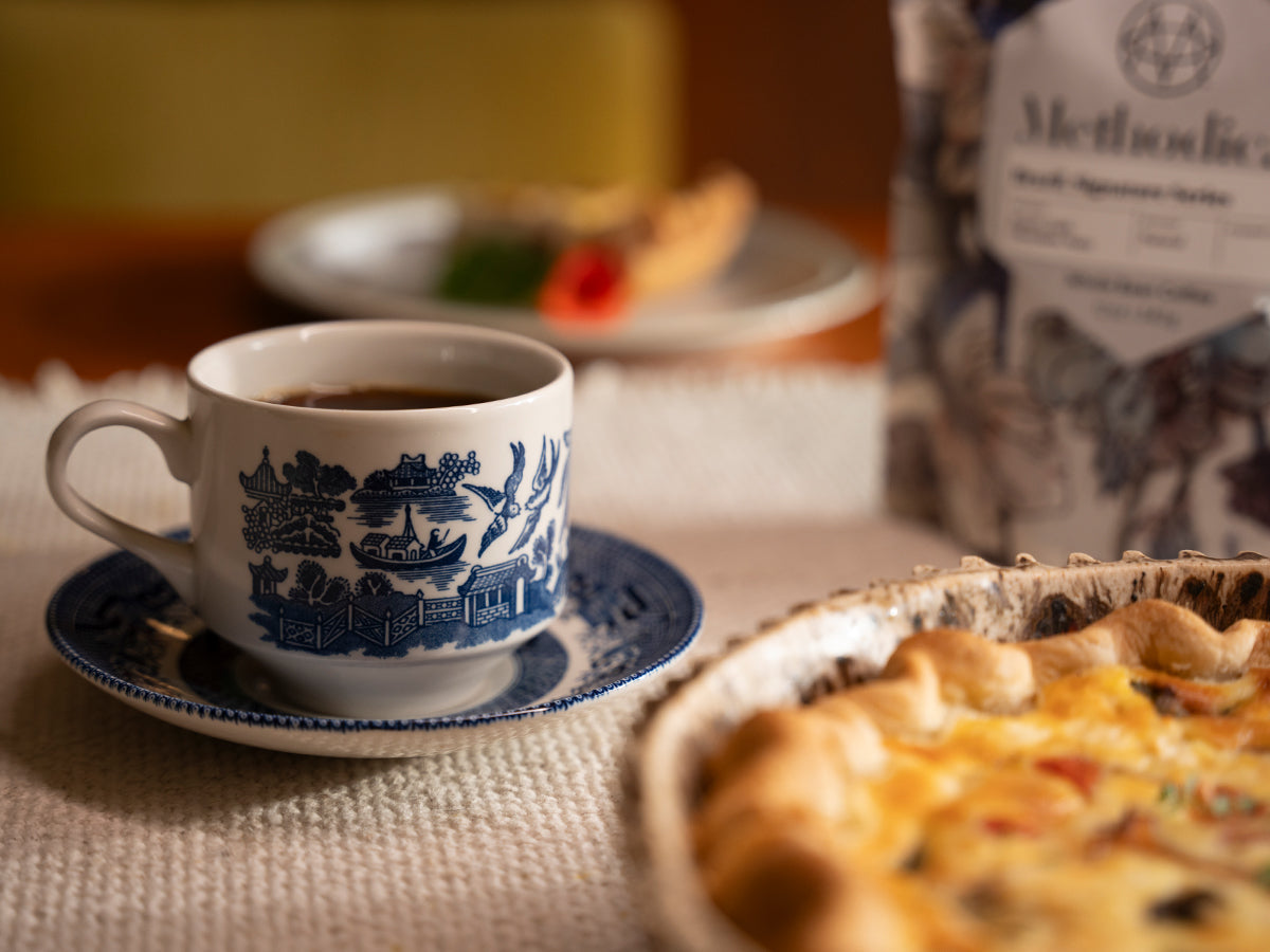 A cup of coffee paired with a quiche